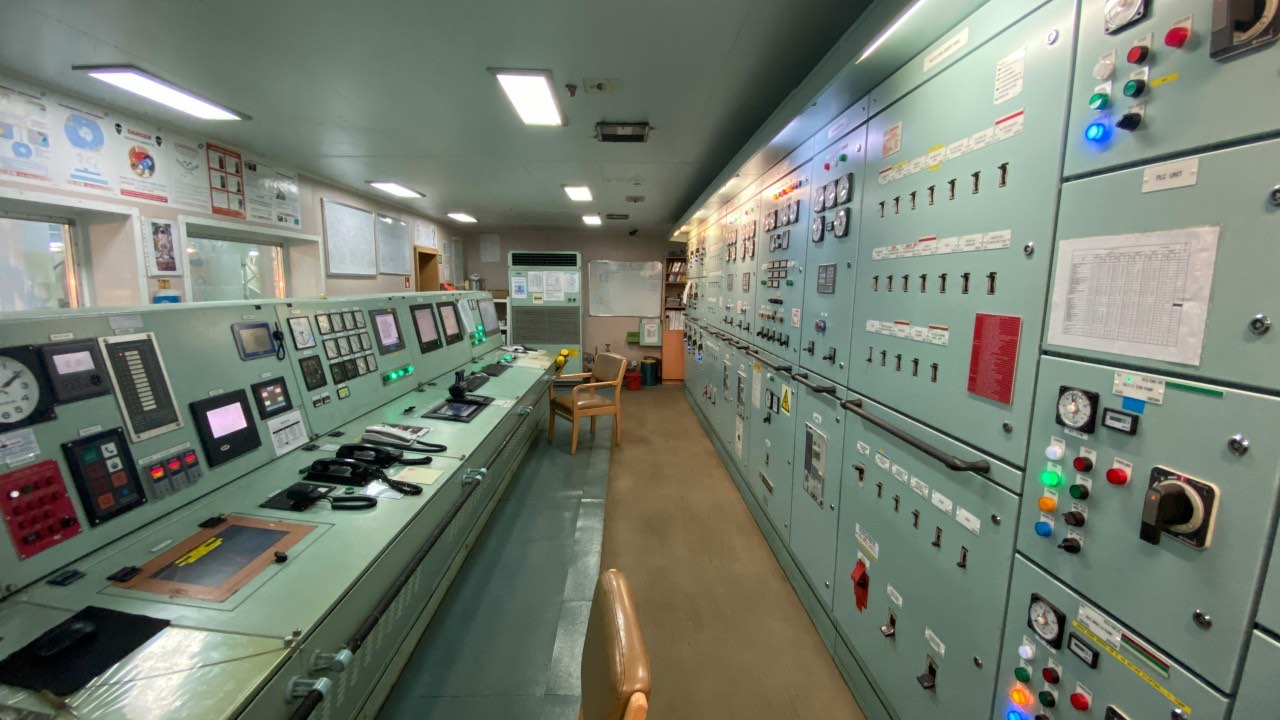 An industrial control room lined with banks of instruments, gauges, and switches — the kind of tightly coupled system Charles Perrow studied.